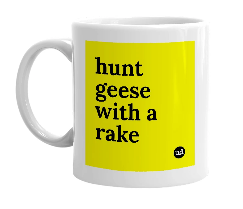 White mug with 'hunt geese with a rake' in bold black letters