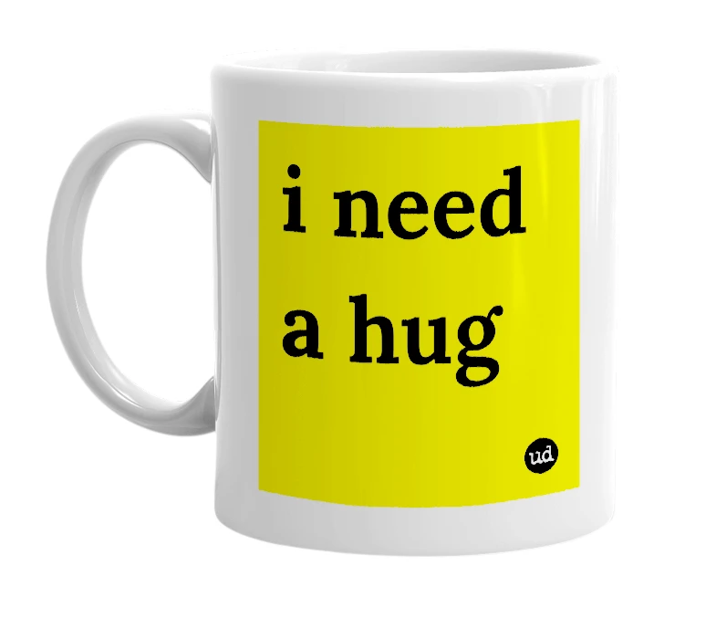 White mug with 'i need a hug' in bold black letters