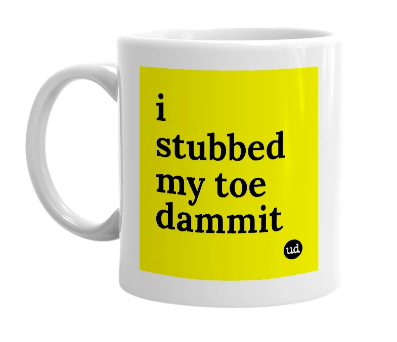 White mug with 'i stubbed my toe dammit' in bold black letters
