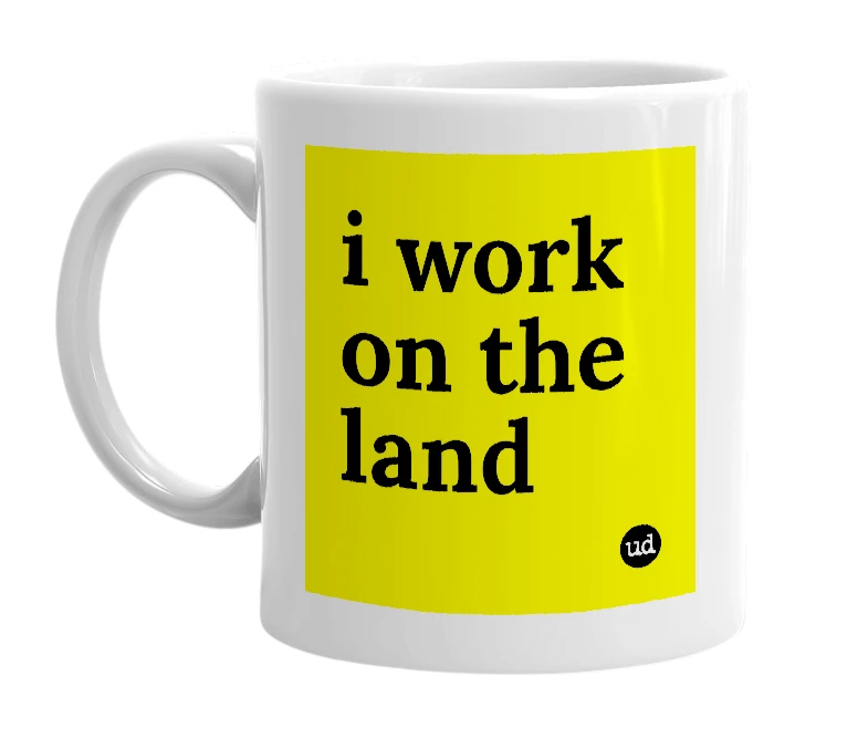 White mug with 'i work on the land' in bold black letters