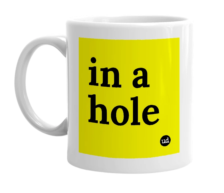 White mug with 'in a hole' in bold black letters