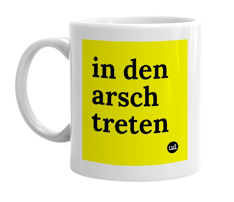 White mug with 'in den arsch treten' in bold black letters