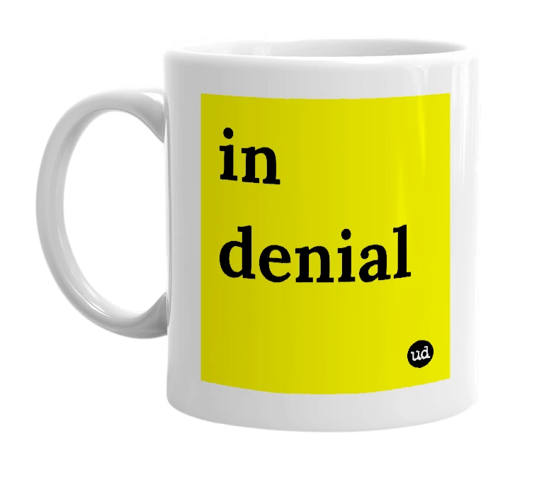 White mug with 'in denial' in bold black letters