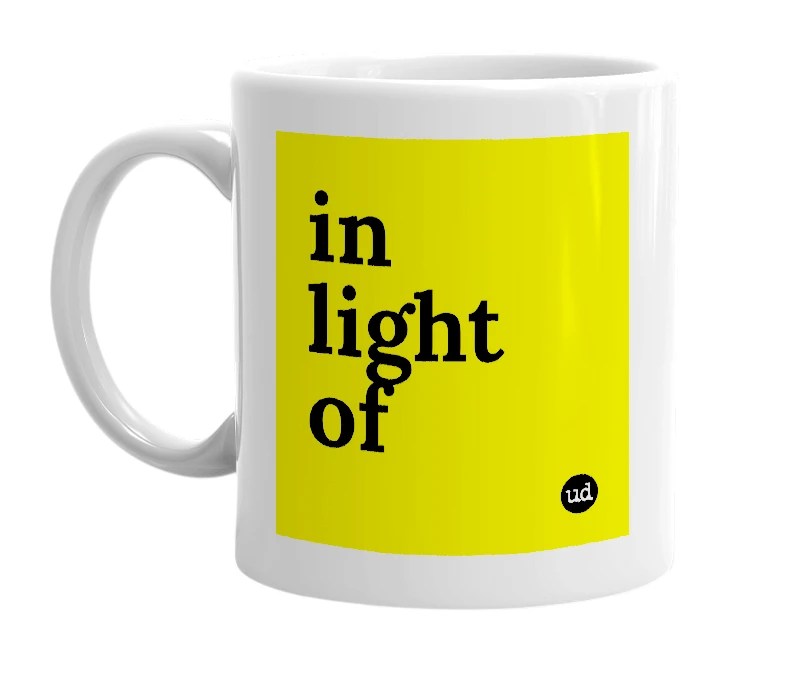 White mug with 'in light of' in bold black letters