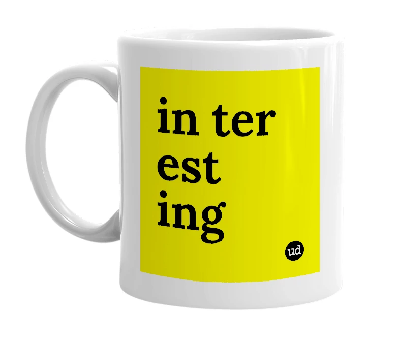 White mug with 'in ter est ing' in bold black letters
