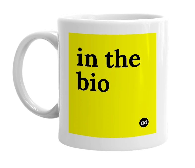 White mug with 'in the bio' in bold black letters