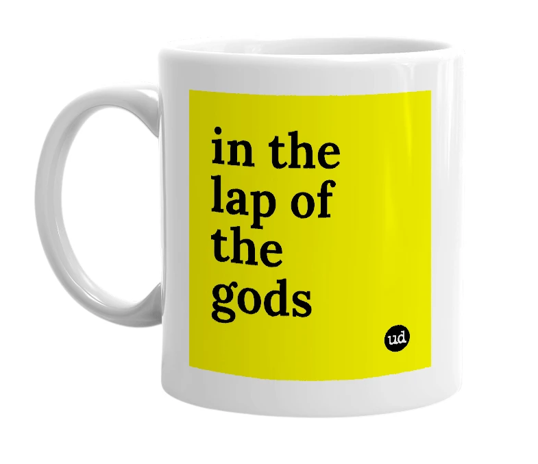 White mug with 'in the lap of the gods' in bold black letters