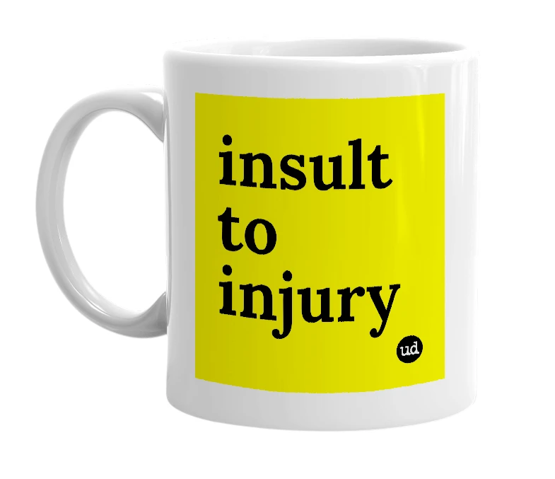 White mug with 'insult to injury' in bold black letters