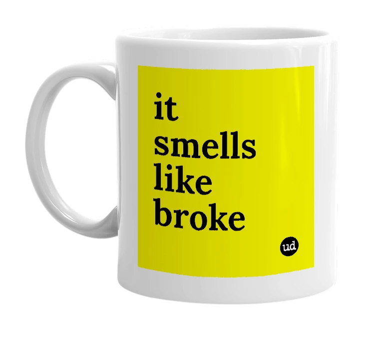 White mug with 'it smells like broke' in bold black letters