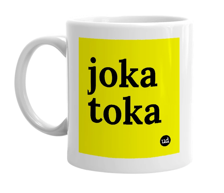 White mug with 'joka toka' in bold black letters