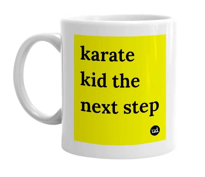 White mug with 'karate kid the next step' in bold black letters