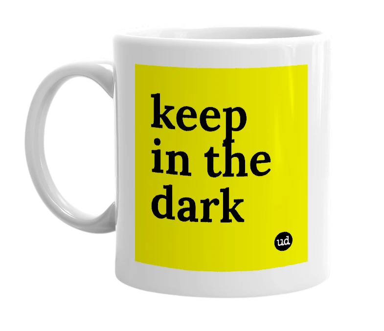 White mug with 'keep in the dark' in bold black letters