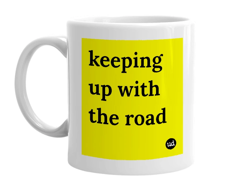 White mug with 'keeping up with the road' in bold black letters