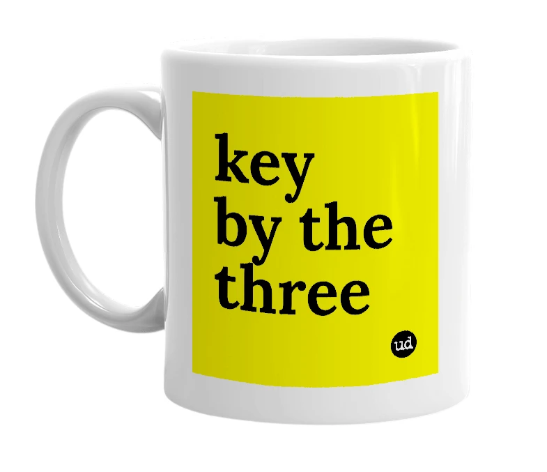 White mug with 'key by the three' in bold black letters