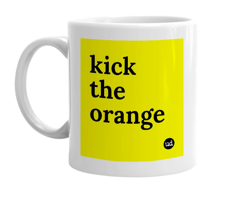White mug with 'kick the orange' in bold black letters