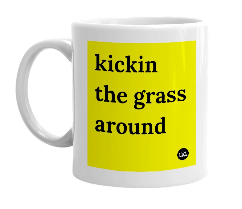 White mug with 'kickin the grass around' in bold black letters