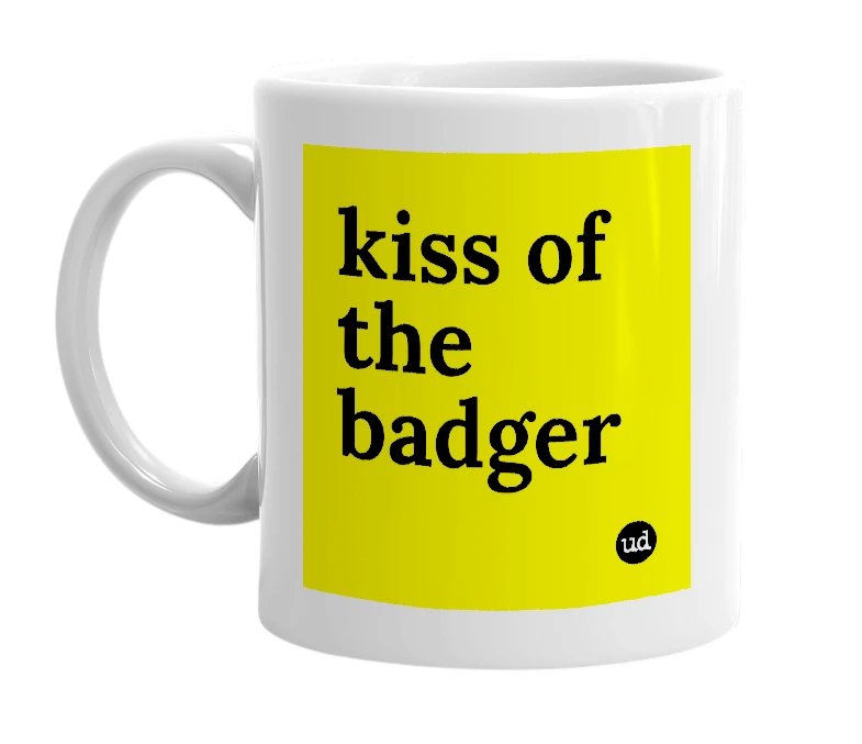 White mug with 'kiss of the badger' in bold black letters