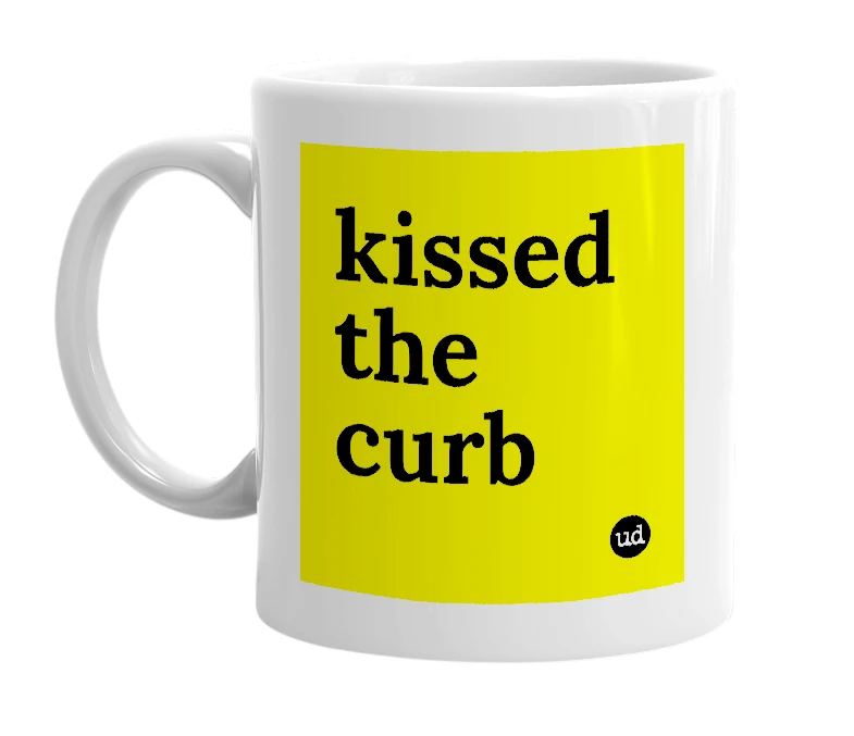 White mug with 'kissed the curb' in bold black letters