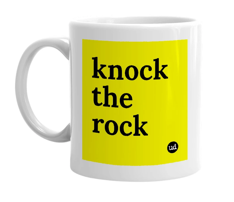 White mug with 'knock the rock' in bold black letters