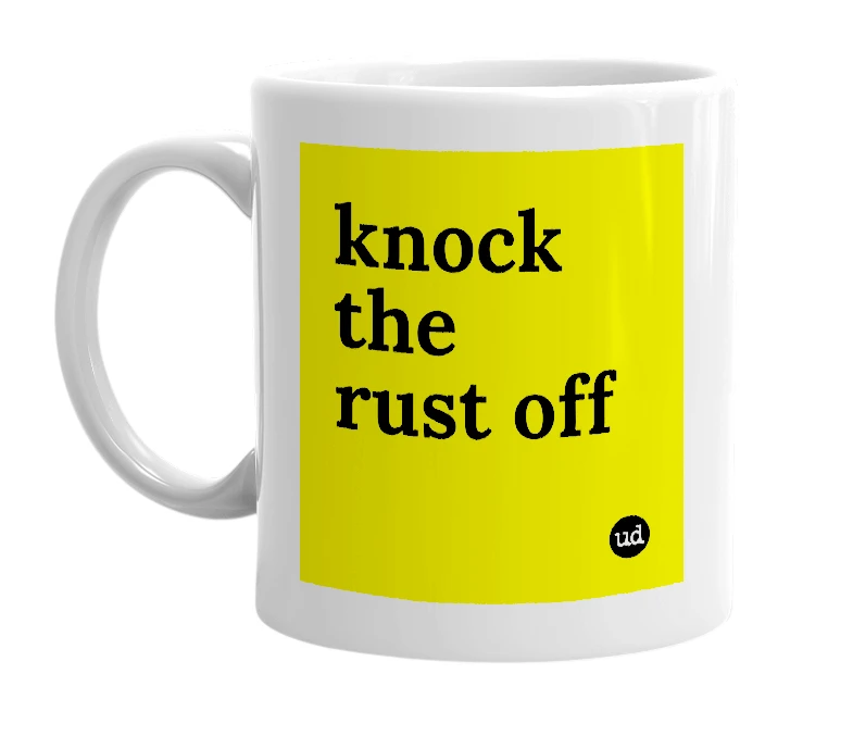 White mug with 'knock the rust off' in bold black letters