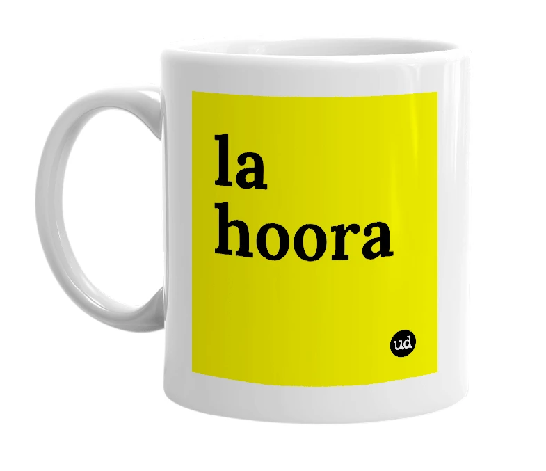 White mug with 'la hoora' in bold black letters