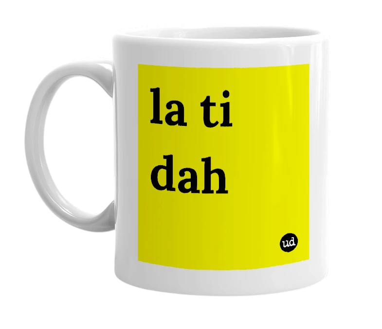 White mug with 'la ti dah' in bold black letters