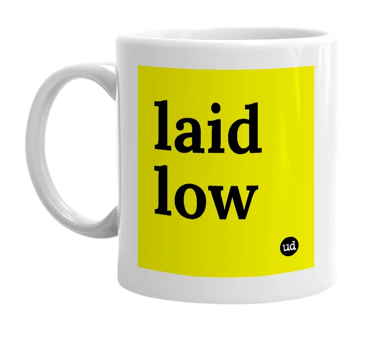 White mug with 'laid low' in bold black letters