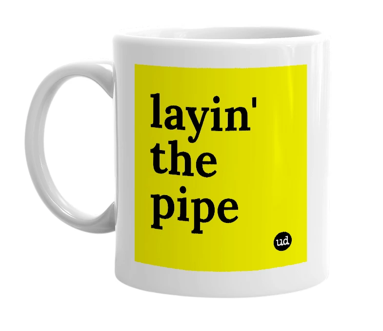 White mug with 'layin' the pipe' in bold black letters