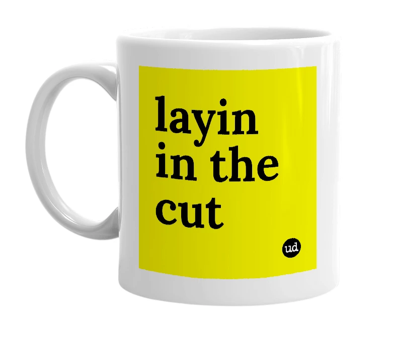 White mug with 'layin in the cut' in bold black letters