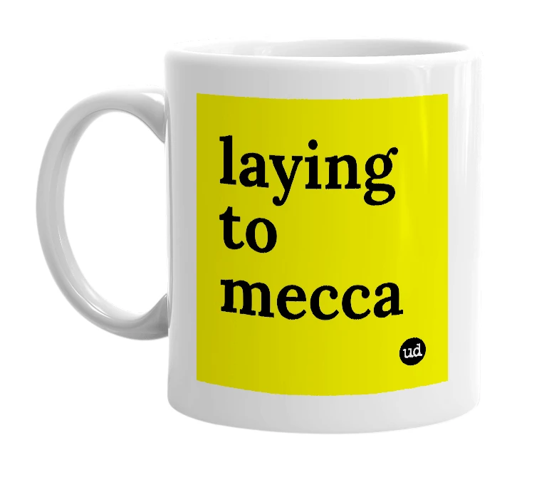 White mug with 'laying to mecca' in bold black letters