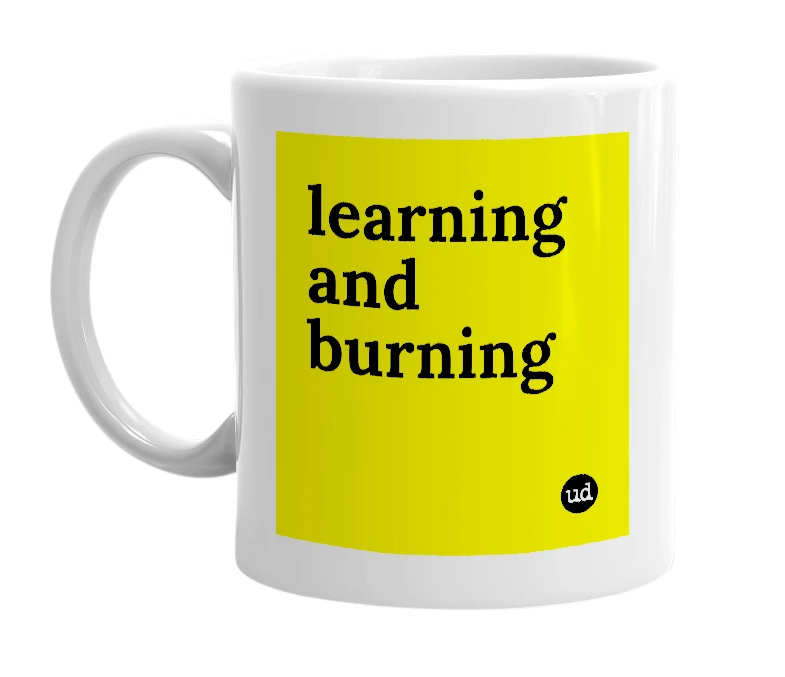 White mug with 'learning and burning' in bold black letters