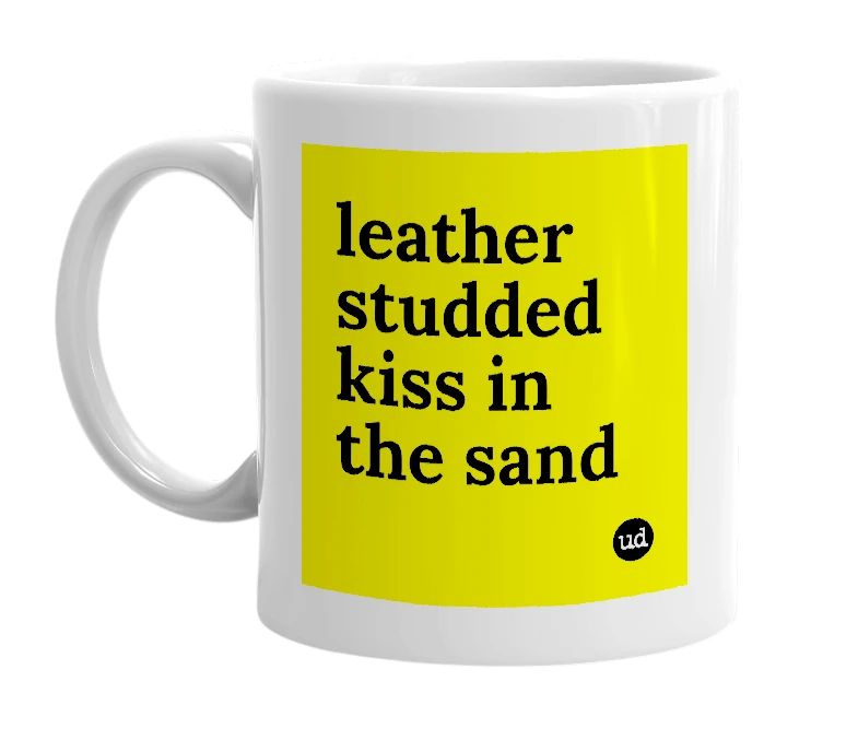 White mug with 'leather studded kiss in the sand' in bold black letters