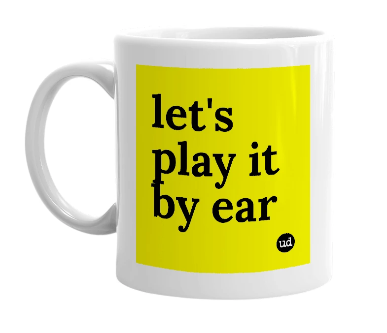 White mug with 'let's play it by ear' in bold black letters