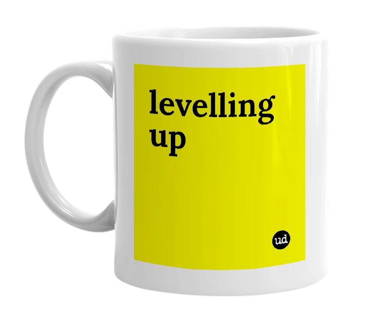 White mug with 'levelling up' in bold black letters