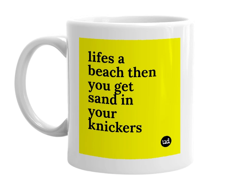 White mug with 'lifes a beach then you get sand in your knickers' in bold black letters