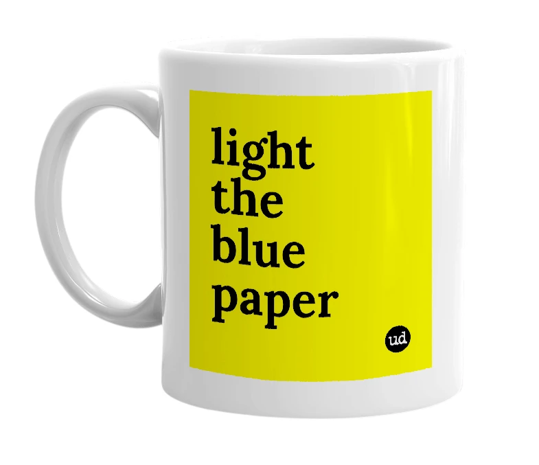 White mug with 'light the blue paper' in bold black letters