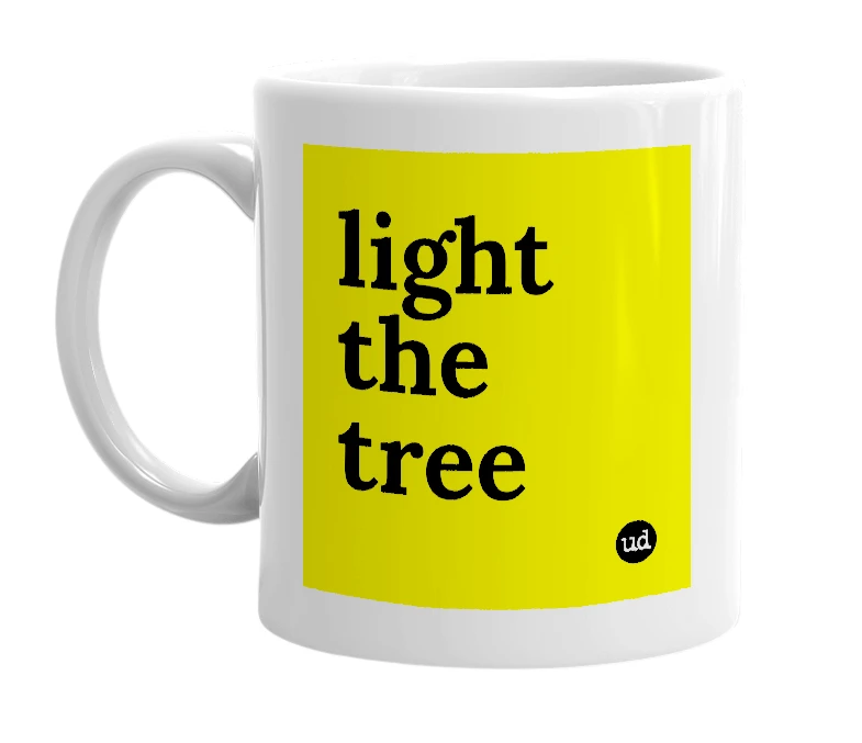 White mug with 'light the tree' in bold black letters