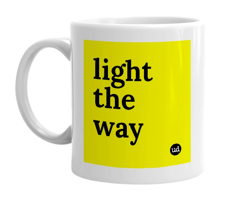 White mug with 'light the way' in bold black letters