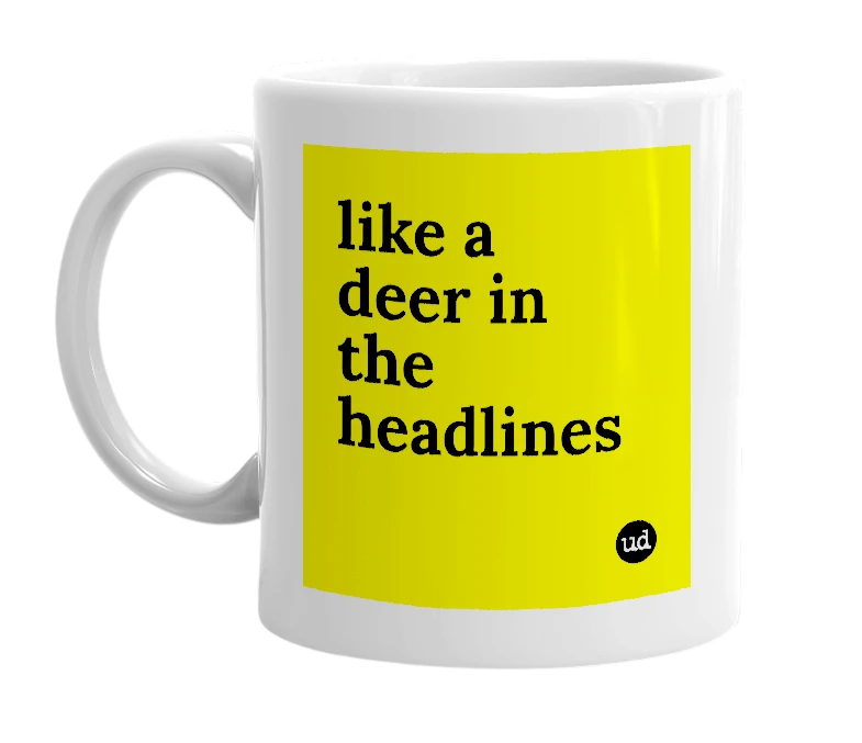 White mug with 'like a deer in the headlines' in bold black letters