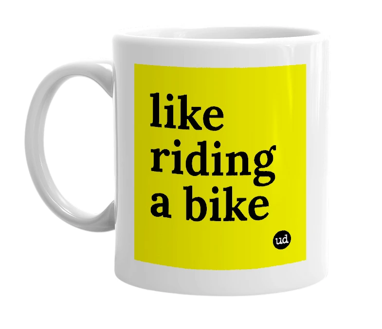 White mug with 'like riding a bike' in bold black letters