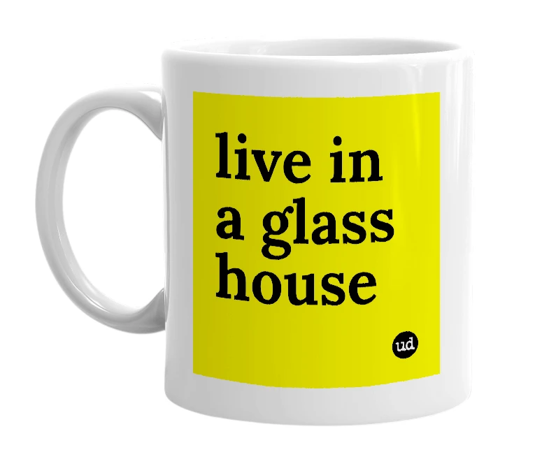 White mug with 'live in a glass house' in bold black letters