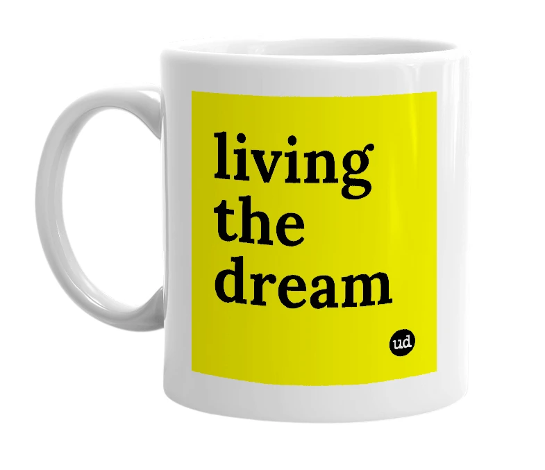 White mug with 'living the dream' in bold black letters