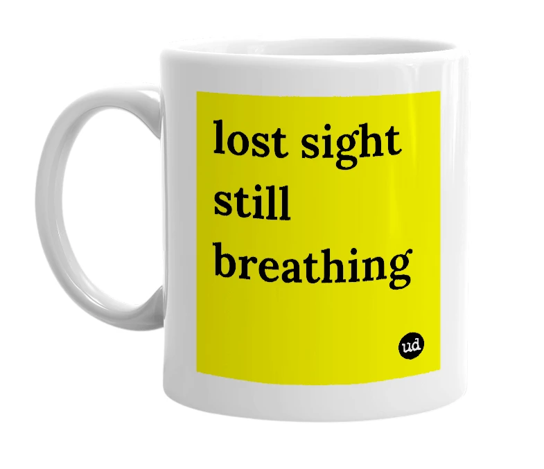 White mug with 'lost sight still breathing' in bold black letters