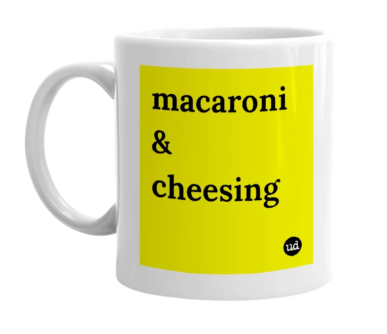 White mug with 'macaroni & cheesing' in bold black letters