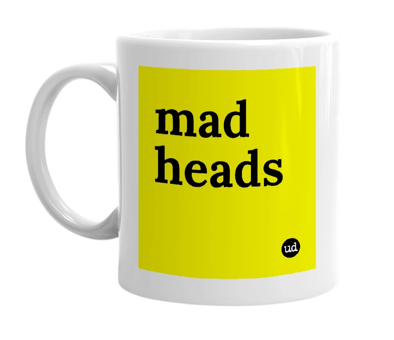 White mug with 'mad heads' in bold black letters