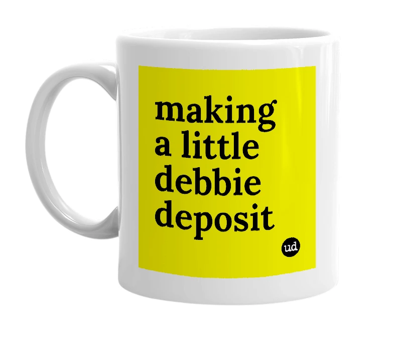 White mug with 'making a little debbie deposit' in bold black letters