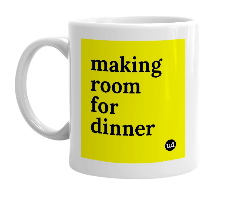 White mug with 'making room for dinner' in bold black letters