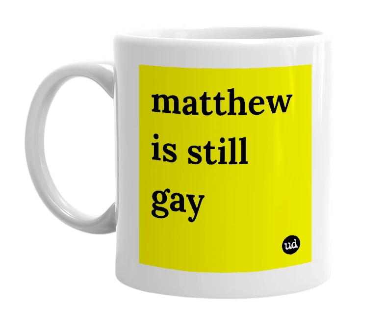 White mug with 'matthew is still gay' in bold black letters