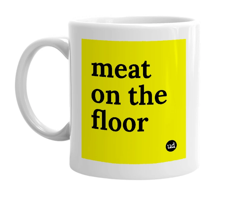 White mug with 'meat on the floor' in bold black letters