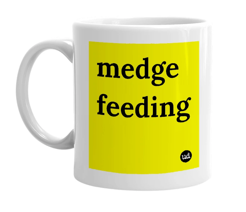 White mug with 'medge feeding' in bold black letters